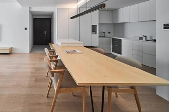 white kitchen with long wooden table